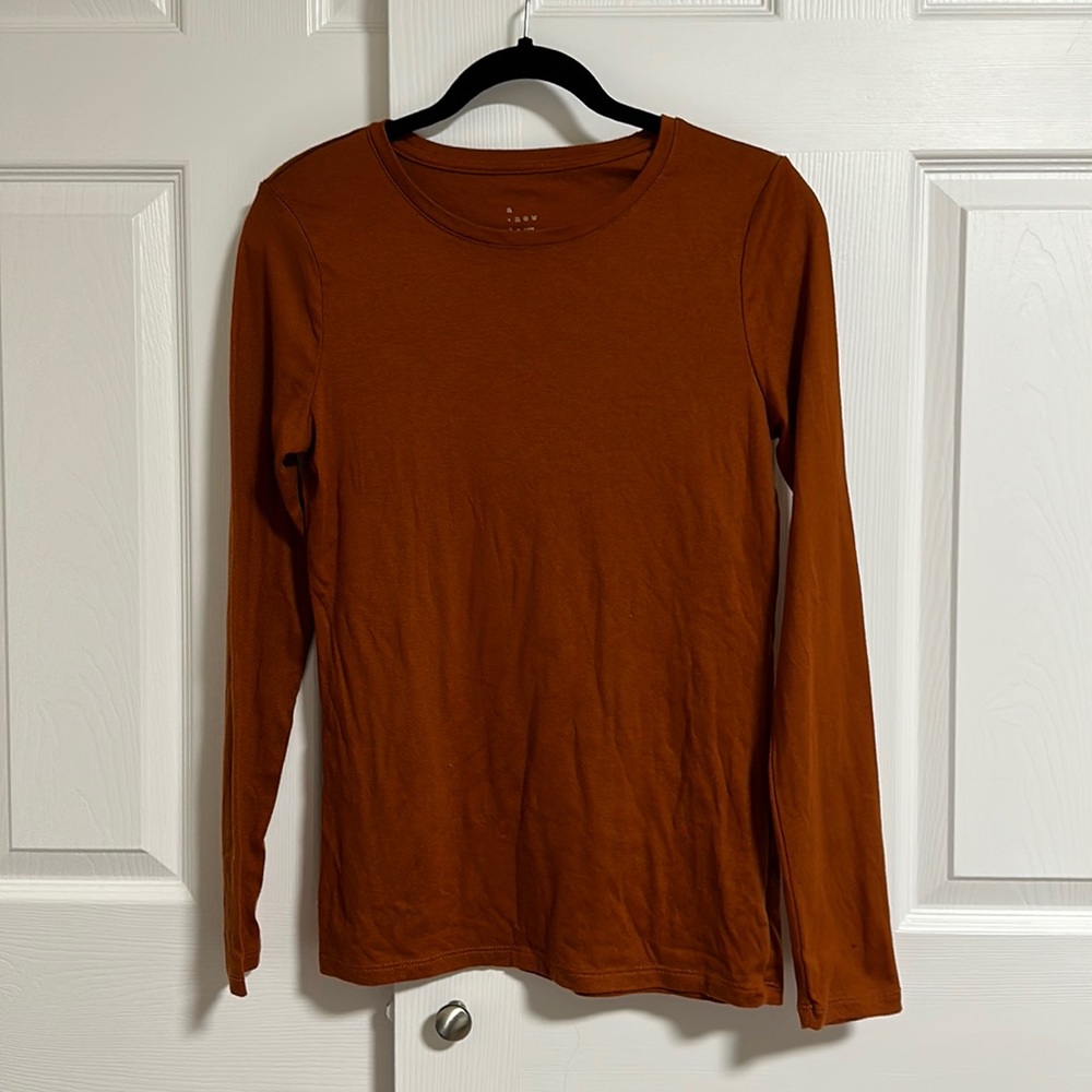 A new day. Orange long sleeve shirt.